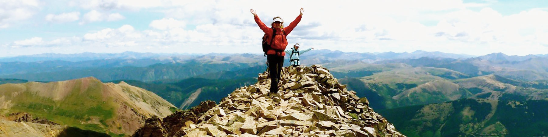 Beth Wille touches the sky as she conquers the North Maroon Peak ascent