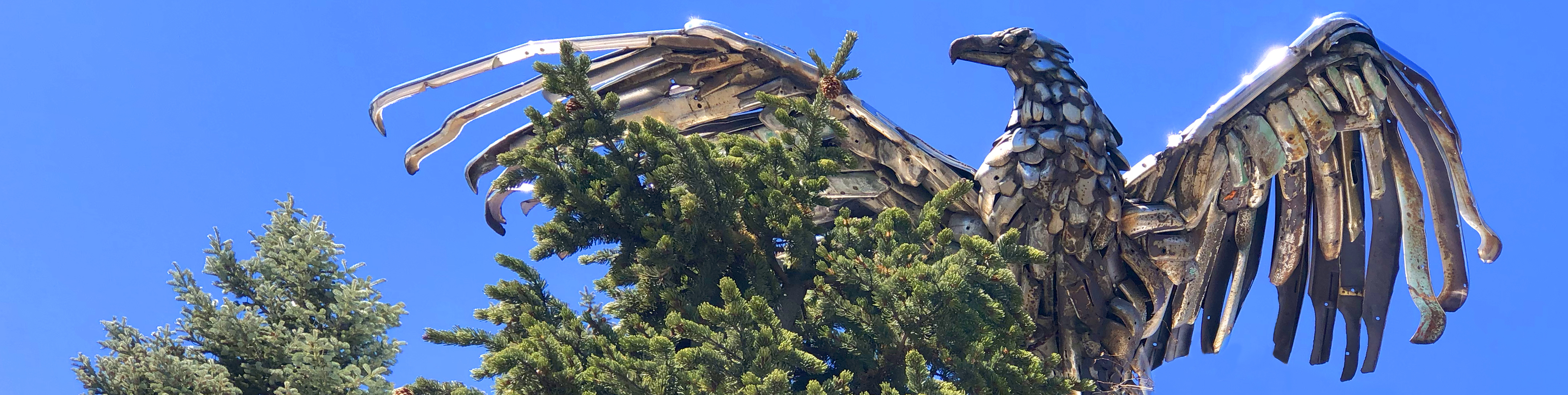 Lou Wille’s iconic chrome bumper eagle sculpture stands guard from atop the Tyrolean Lodge, ever vigilant